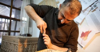 Master woodcarver Süleyman Daştan, 42, at work hand carving with a chisel, Sivas, central Turkey, Nov. 18, 2021 (AA Photo)