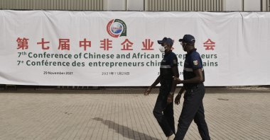 Security officers walk past a banner at the entrance of a conference hall during the China-Africa Cooperation (FOCAC) meeting at the Diamniadio in Dakar, Senegal, on Nov. 29, 2021. (AFP Photo)