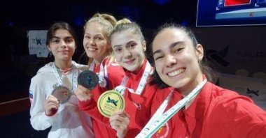 World Taekwondo Champion in the 53-kilogram category Mamak Municipality athlete Merve Dinçel (2-R) can be seen with her medal, Ankara, Turkey, Nov. 29, 2021. (IHA Photo)