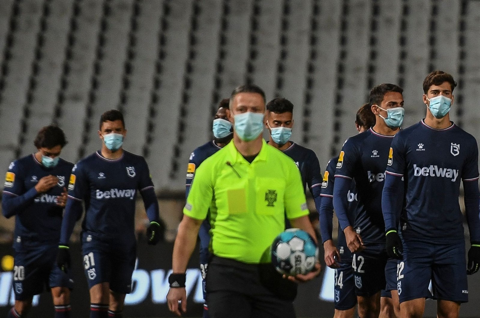 Belenenses players arrive at the pitch before a Portuguese league match against Benfica Oeiras, Portugal, Nov, 27, 2021. (AFP Photo)