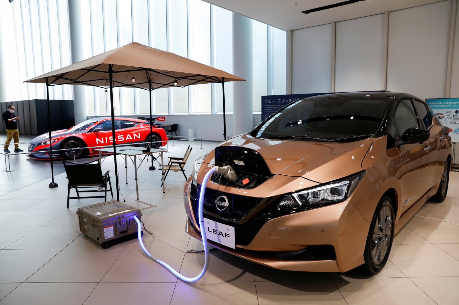 A Nissan Leaf EV car and portable battery on display at Nissan Gallery in Yokohama, Japan, Nov. 29, 2021. (Reuters Photo)