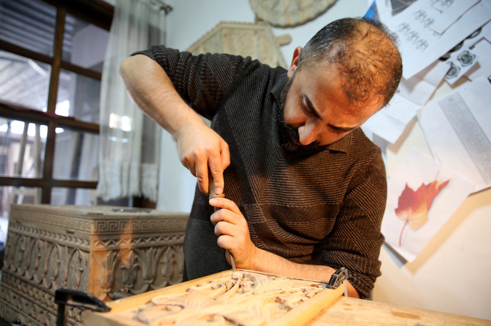 Master woodcarver Süleyman Daştan, 42, at work hand carving with a chisel, Sivas, central Turkey, Nov. 18, 2021 (AA Photo)