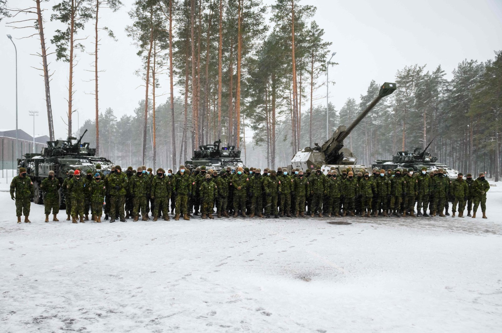 Canadian military troops stand guard for a picture at the Adazi military base, Latvia, Nov. 29, 2021. (AFP Photo)