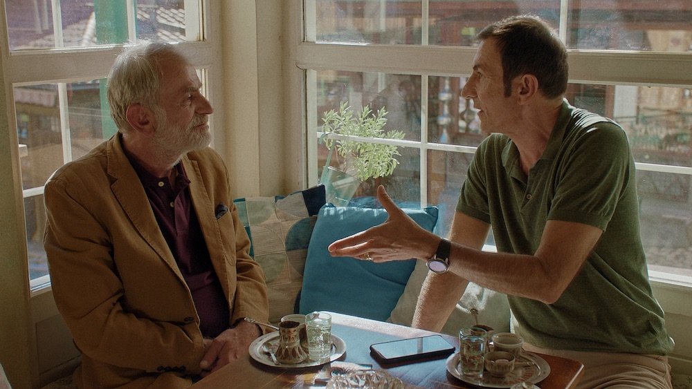 A still shot from “Not So Neighbourly Affair” shows Branko Duric (R) as Enis and Izudin Bajrovic as Izo.