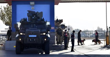 Police officers and soldiers stand at the entrance of a courthouse before the trial of 475 defendants in Sincan, Ankara, Turkey, Nov. 26, 2020. (AP Photo)