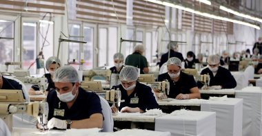 Textile workers produce protective face masks at a textile atelier in Ankara, Turkey, March 26, 2020. (AA Photo)