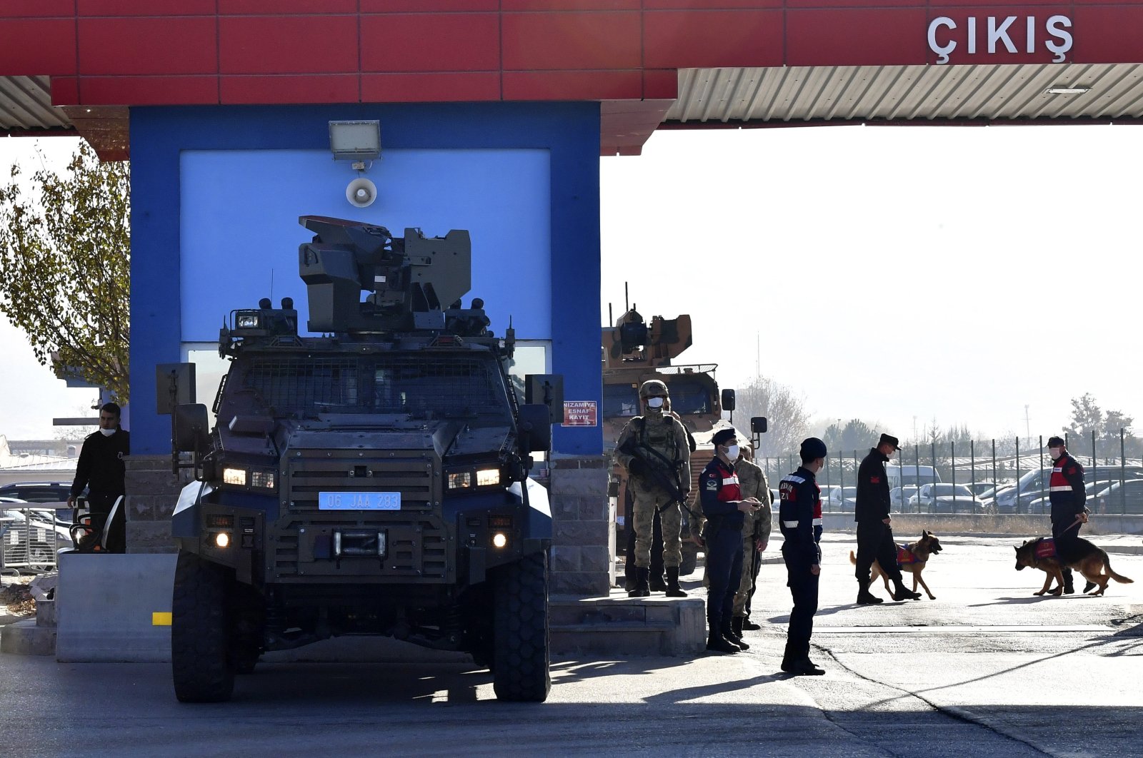Police officers and soldiers stand at the entrance of a courthouse before the trial of 475 defendants in Sincan, Ankara, Turkey, Nov. 26, 2020. (AP Photo)