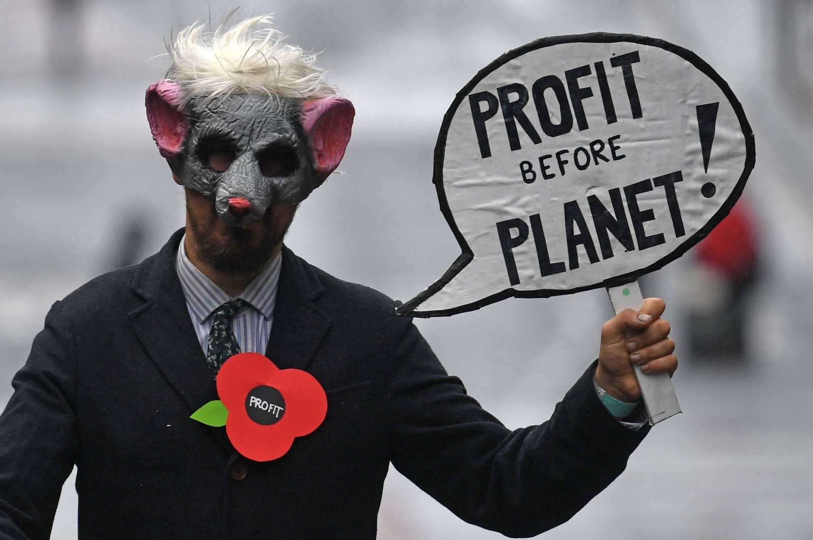 A demonstrator holds a placard as he attends a protest rally during a global day of action on climate change in Glasgow, Scotland, Nov. 6, 2021. (AFP Photo)
