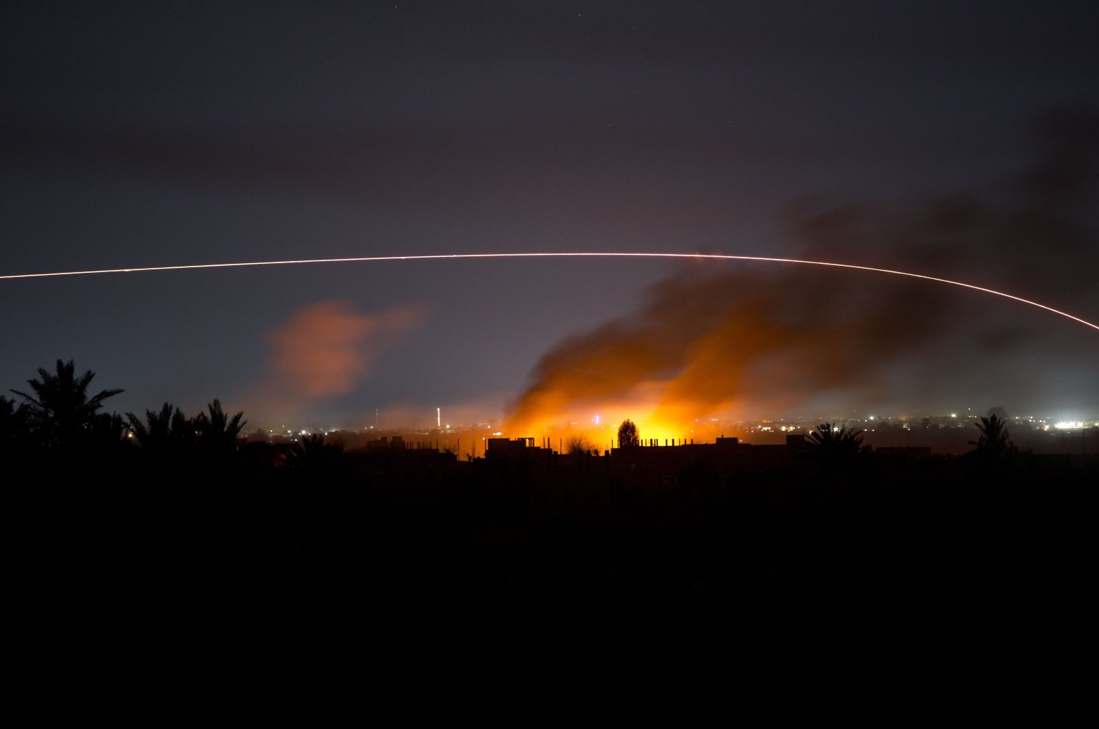 Tracer fire lights up the night sky as U.S.-backed YPG/PKK terrorists fire on the Daesh-held village of Baghouz, Syria, Tuesday, March 12, 2019. (AP File Photo)