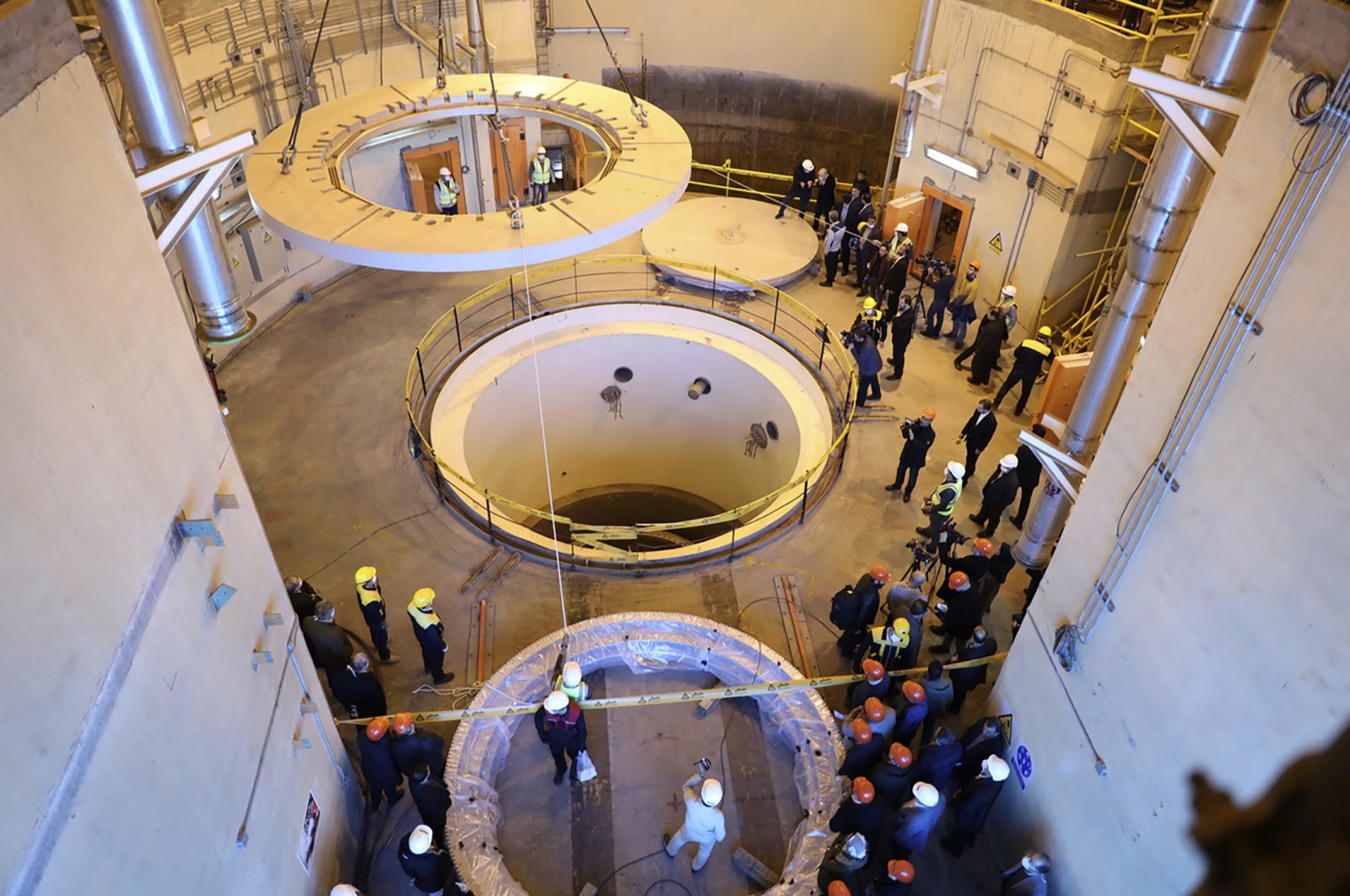 In this photo released by the Atomic Energy Organization of Iran, technicians work at the Arak heavy water reactor&#039;s secondary circuit, as officials and media visit the site, near Arak, 150 miles (250 kilometers) southwest of the capital Tehran, Iran, Dec. 23, 2019. (AP Photo)