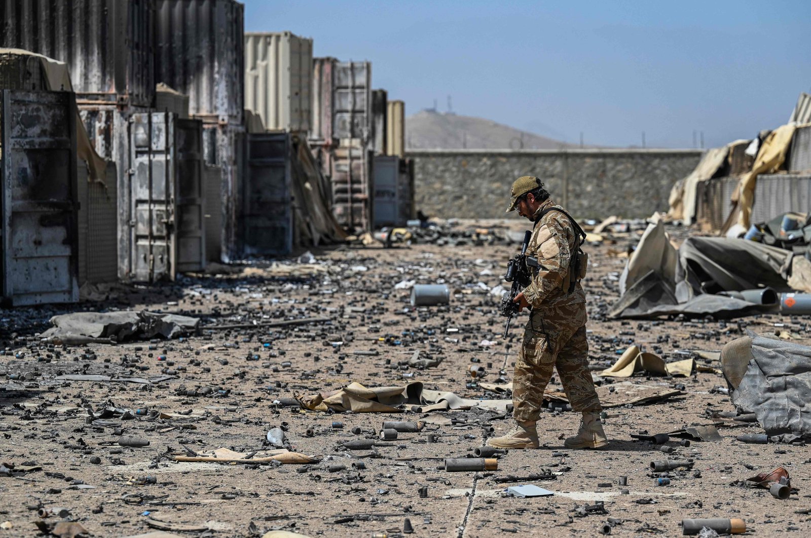 In this file photo, a member of the Taliban Badri 313 military unit walks amid debris of the destroyed Central Intelligence Agency (CIA) base in Deh Sabz district northeast of Kabul after the U.S. pulled all its troops out of the country, Kabul, Afghanistan, Sept. 6, 2021 (AFP Photo)