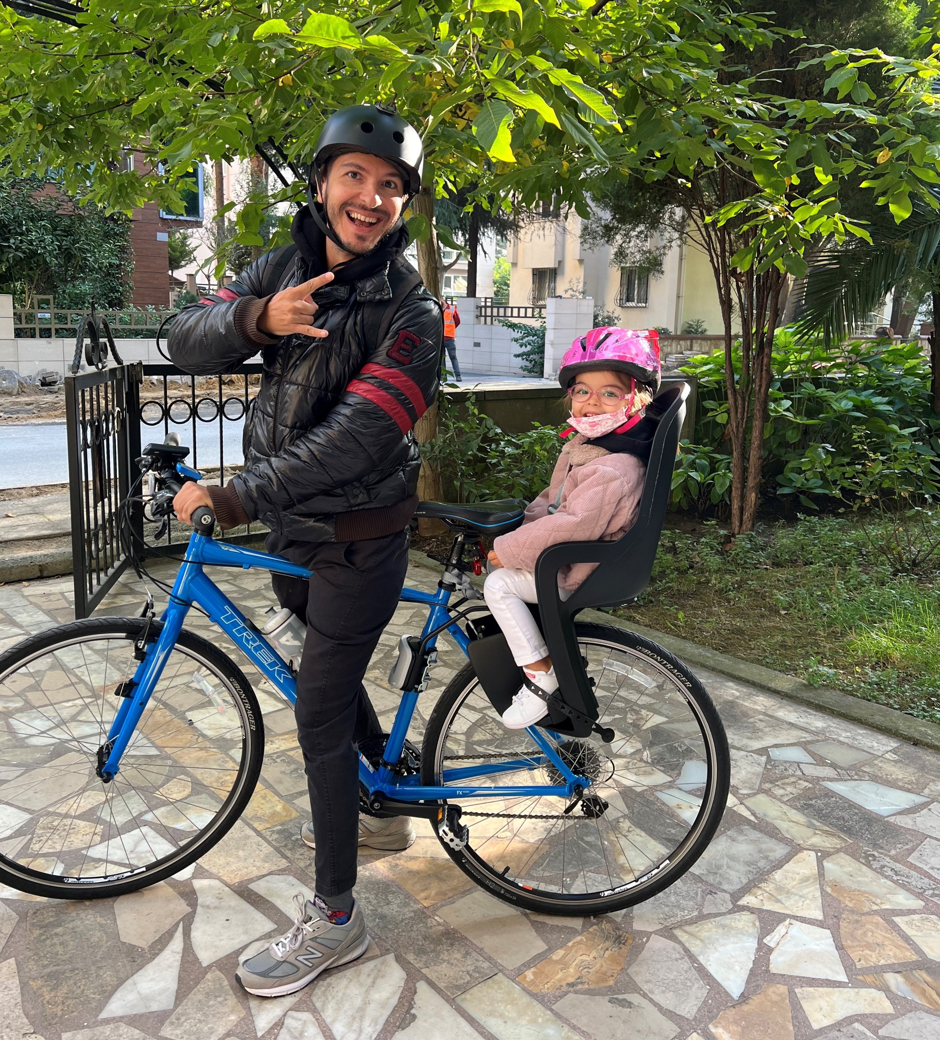 Celal Tolga Imamoğlu and his 3-year-old daughter pose on their bicycle in front of their house. (Courtesy of Celal Tolga İmamoğlu)