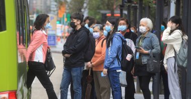 People wearing masks to prevent the spread of COVID-19 wait at a bus stop in Taipei, Taiwan, Nov. 30, 2021. (Reuters Photo)