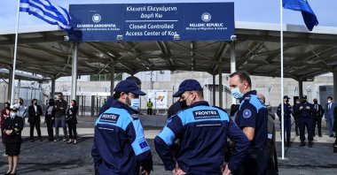 Members of the European Border and Coast Guard Agency Frontex stand outside the new closed migrant camp on the Greek island of Kos, Nov. 27, 2021. (AFP Photo)