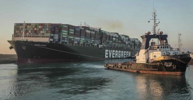 In this photo released by Suez Canal Authority, the Ever Given, a Panama-flagged cargo ship, is pulled by one of the Suez Canal tugboats, in the Suez Canal, Egypt, Monday, March 29, 2021. (Suez Canal Authority via AP)