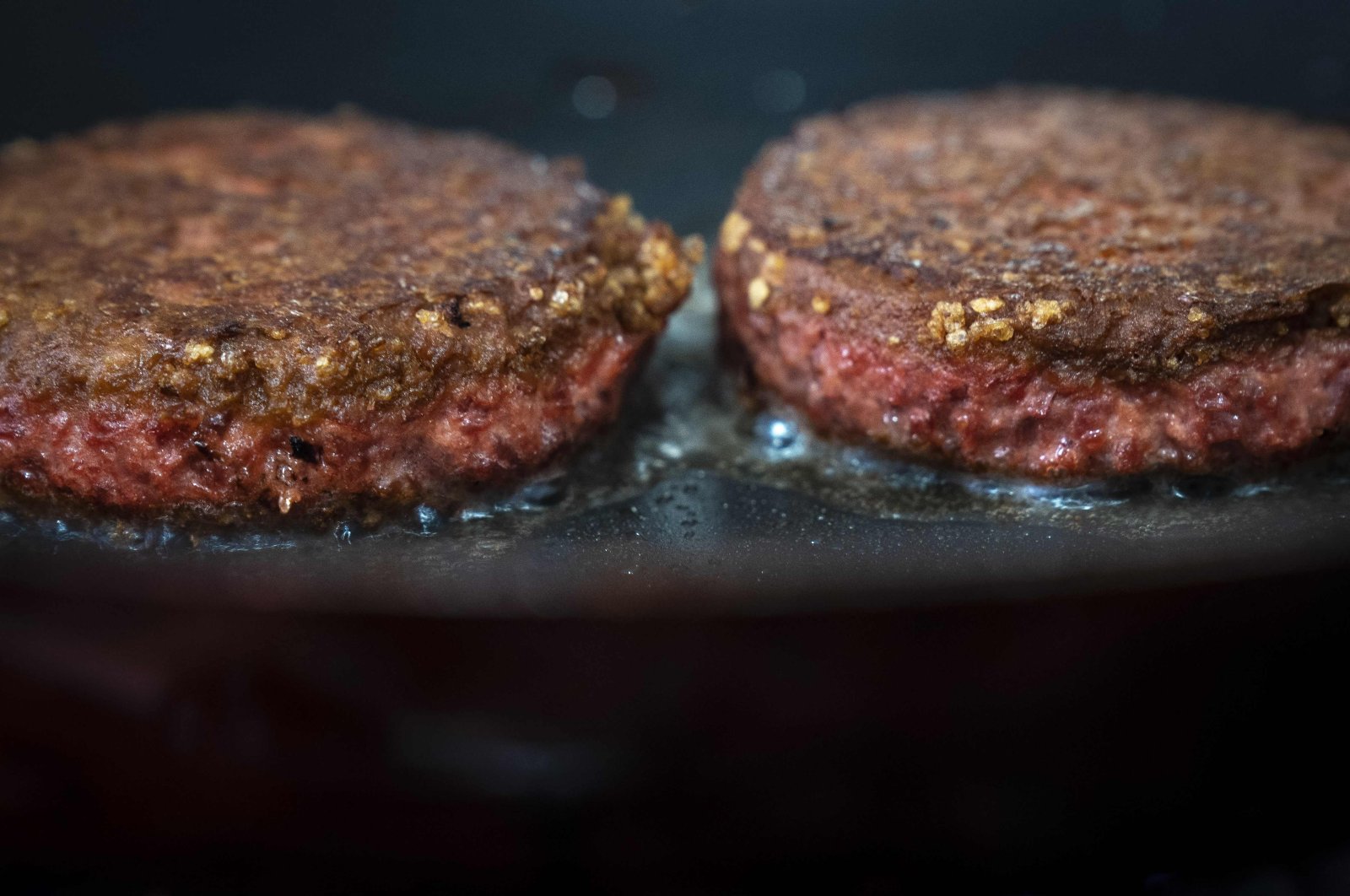 In this photo illustration, two patties of Beyond Meat &quot;The Beyond Burger&quot; cook in a skillet, June 13, 2019 in New York, US. (Getty Images via AFP)