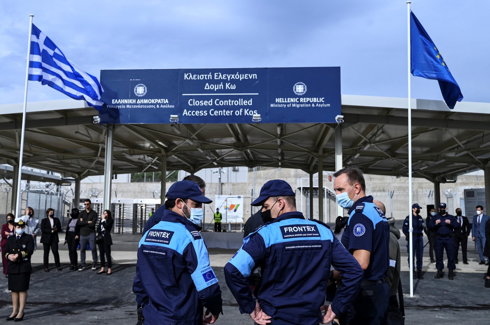 Members of the European Border and Coast Guard Agency Frontex stand outside the new closed migrant camp on the Greek island of Kos, Nov. 27, 2021. (AFP Photo)