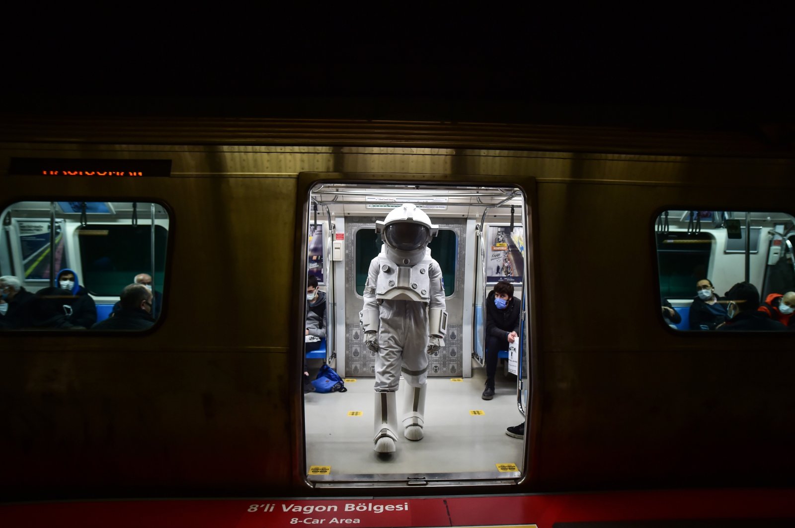 A man in an astronaut suit is seen inside the metro, Istanbul, Turkey, Dec. 1, 2021. (İHA Photo)