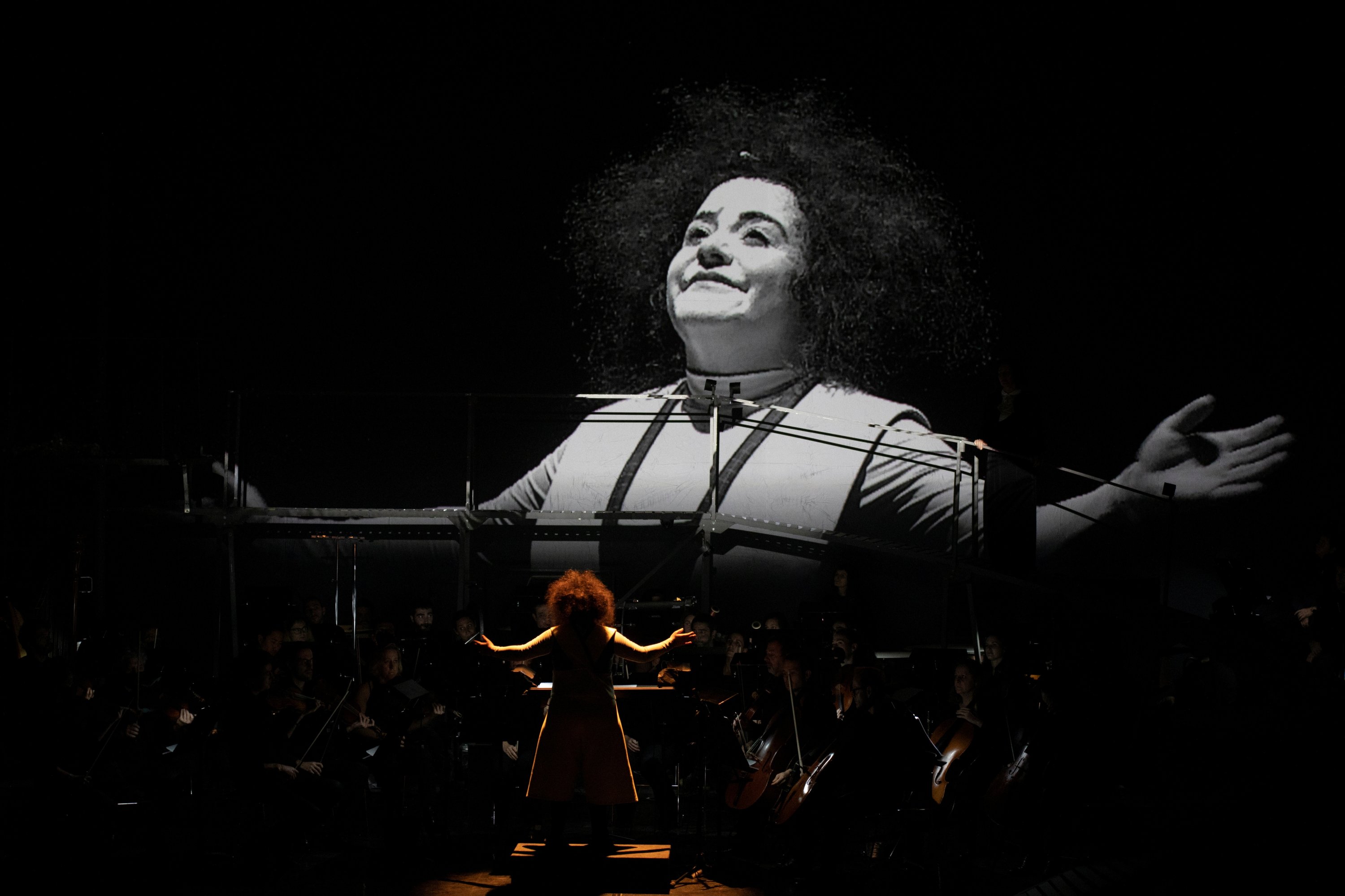 Clown performer Gabriela Munoz stands in front of the GIO Symphonia orchestra during a preview of "The Silence of Sound" in Girona, Spain on November 25, 2021. (REUTERS)