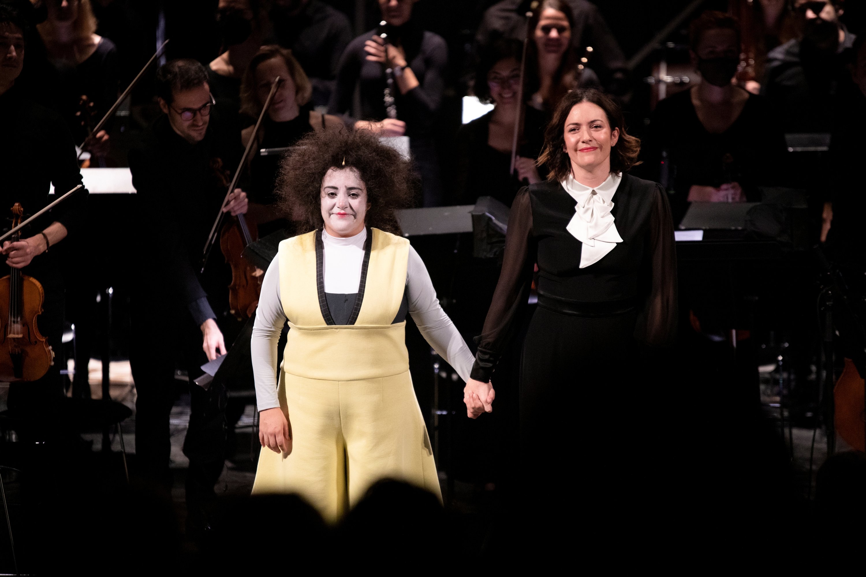 Clown performer Gabriela Munoz and conductor Alondra de la Parra stand in front of audience following a preview performance of "The Silence of Sound" in Girona, Spain, on Nov. 25, 2021. (REUTERS)