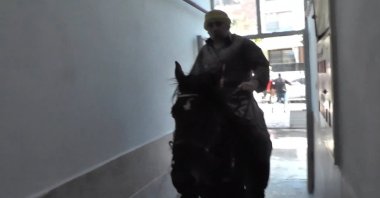 The Turkish man is seen entered an apartment building on horseback, Izmir, Turkey, Dec. 2, 2021. (IHA PHOTO)
