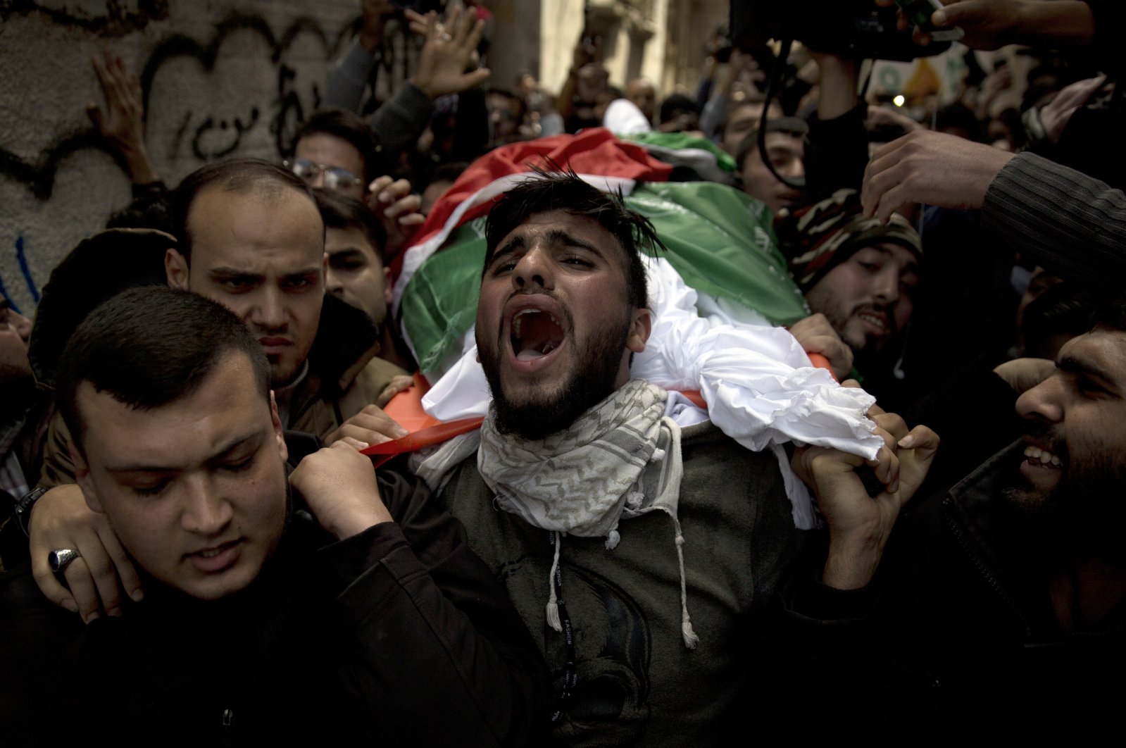 Palestinians carry the body of Tamir Abu al-Khair, 17, who was shot and killed by Israeli troops during a protest next to the Israeli border, eastern Gaza Strip, out of the family home during his funeral in Gaza City, Palestine, March 31, 2019. (AP Photo)