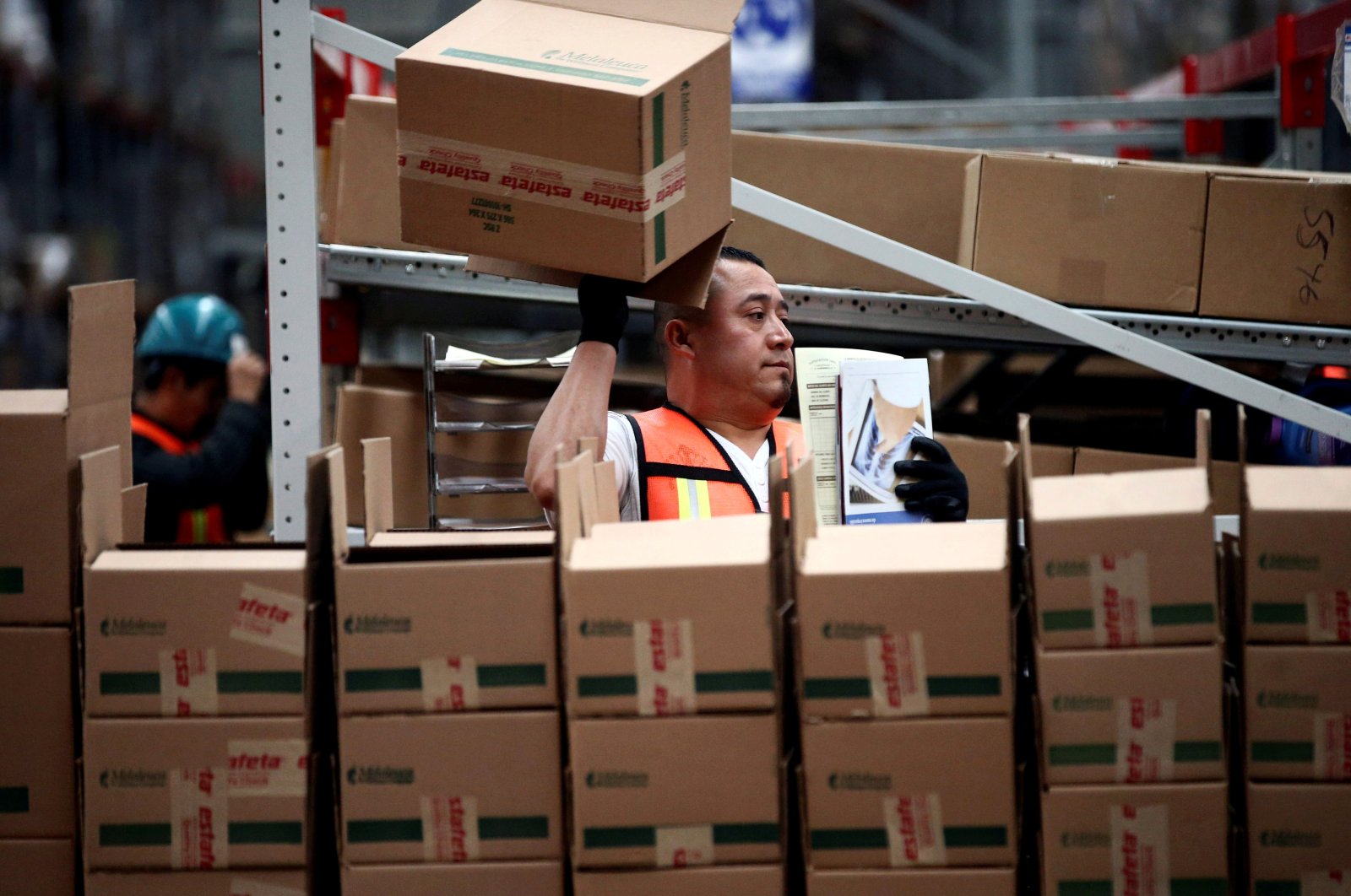An employee of Estafeta Mexicana holds a box as he works at the company&#039;s logistics center in Mexico City, Mexico, April 8, 2019. (Reuters Photo)