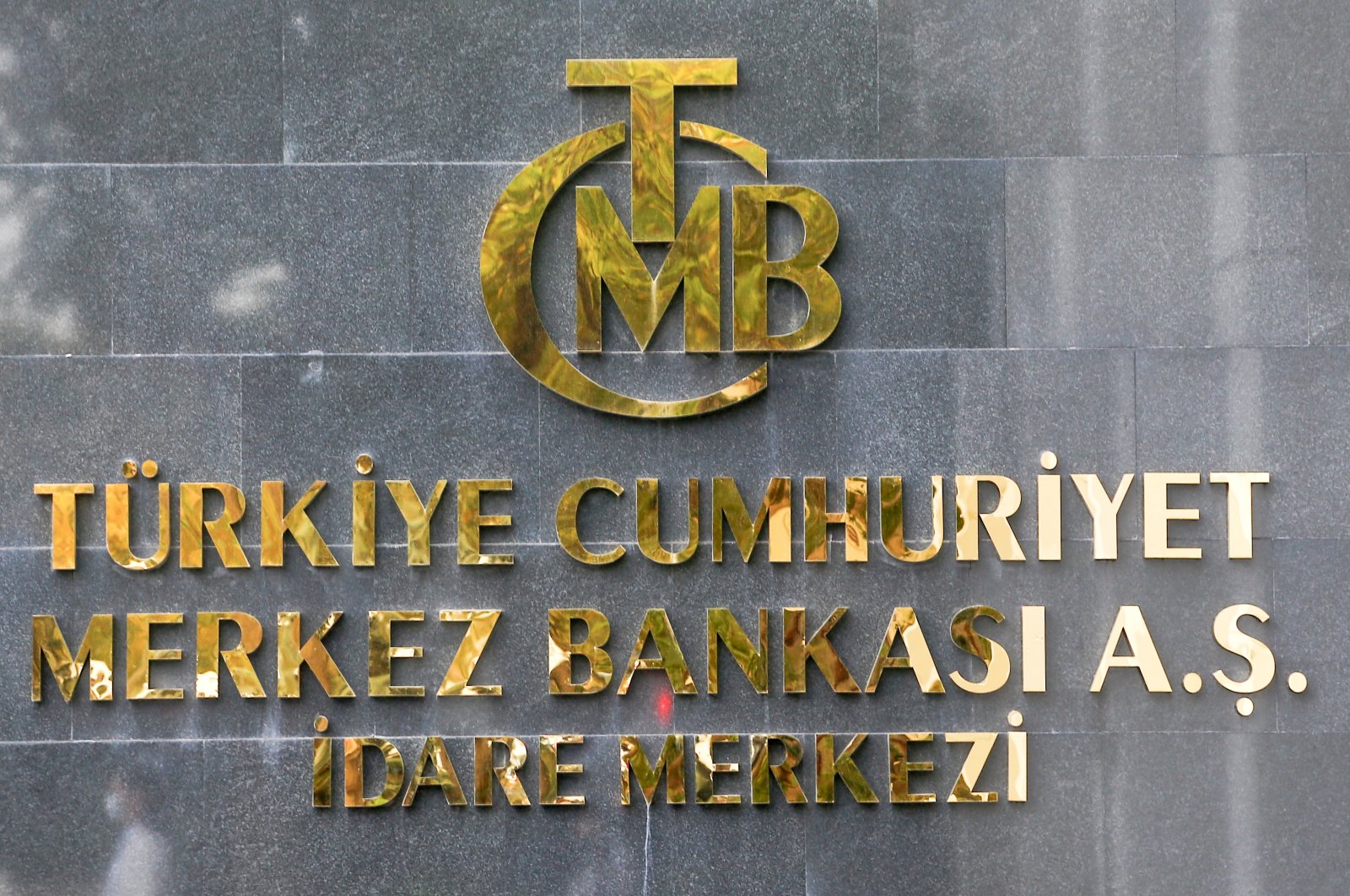 A logo of the Central Bank of the Republic of Turkey (CBRT) is pictured at the entrance of its headquarters in Ankara, Turkey, Oct. 15, 2021. (Reuters Photo)