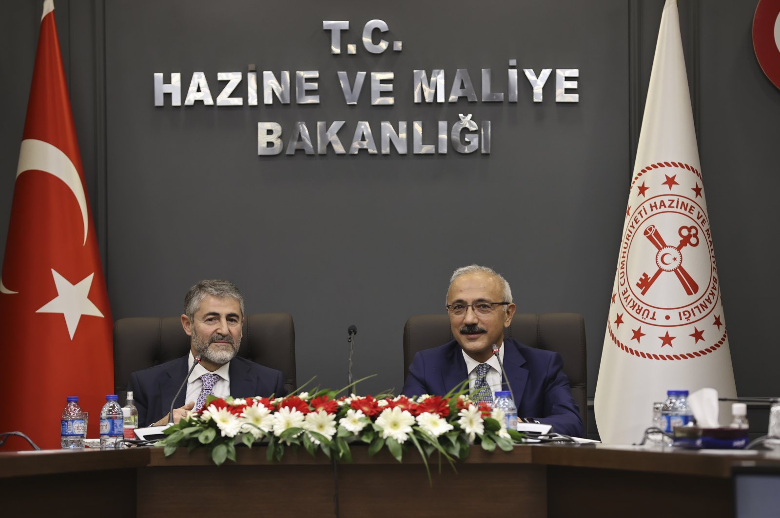 Newly appointed Treasury and Finance Minister Nureddin Nebati (L) and his predecessor Lütfi Elvan attend a handover ceremony in the capital Ankara, Turkey, Dec. 2, 2021. (AA Photo)