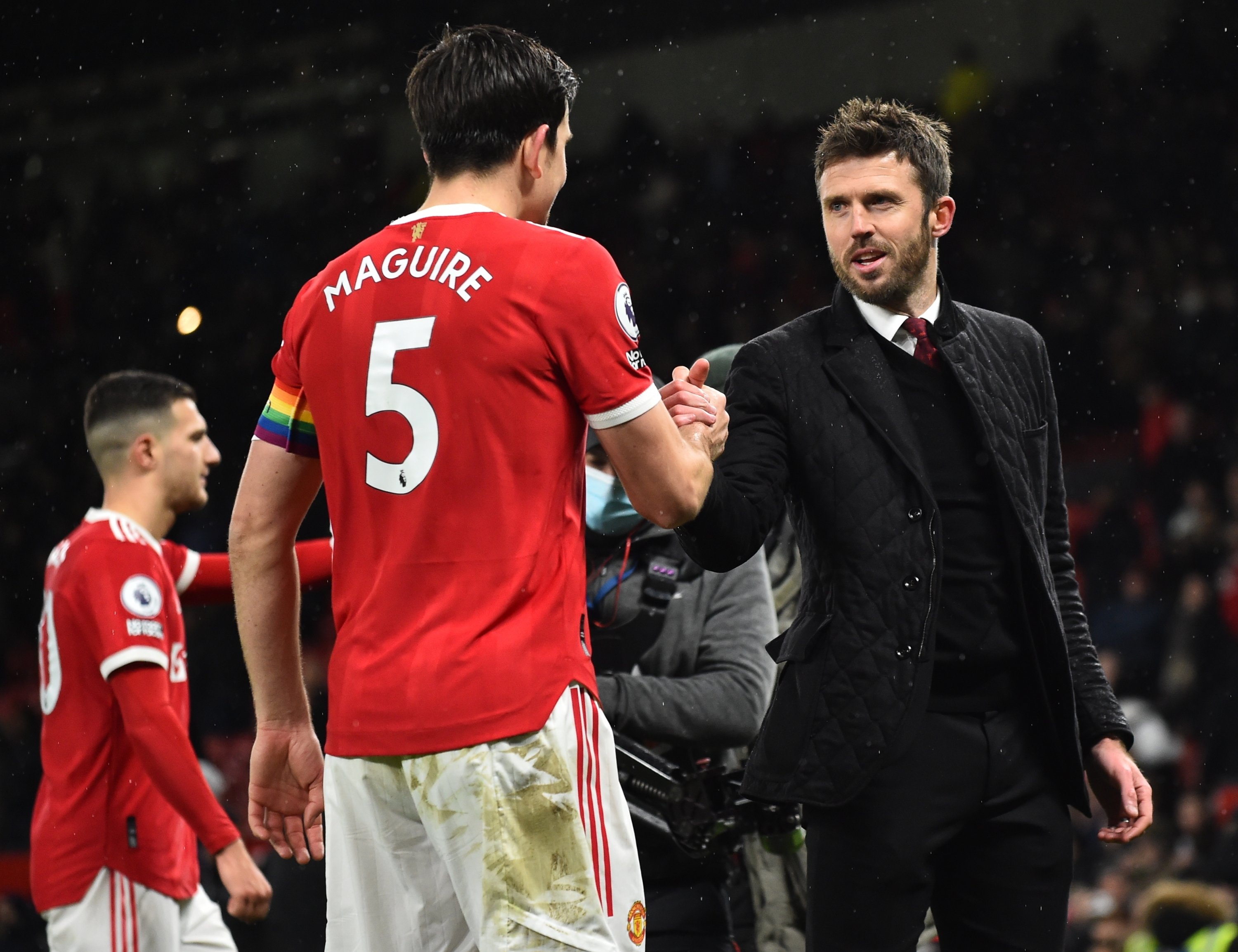Manchester United's Harry Maguire (L) celebrates with manager Michael Carrick (R) after the English Premier League soccer match against Arsenal at Old Trafford in Manchester, England, Dec. 2, 2021. (AFP Photo)