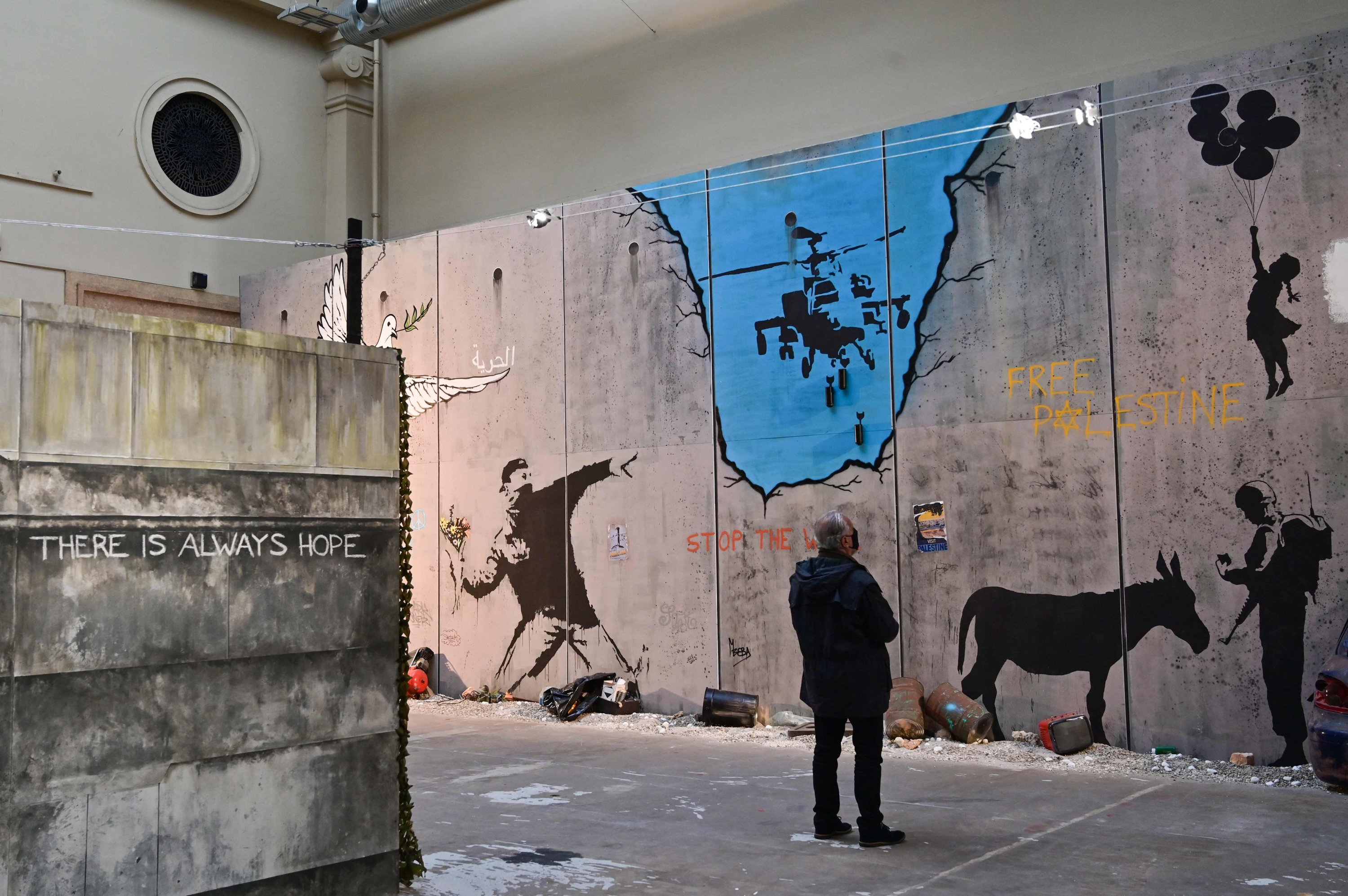 A man looks at British street artist Banksy's mural 
