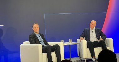 Amazon Web Services CEO Adam Selipsky (L) and Goldman Sachs CEO David Solomon speak during AWS re:Invent 2021, in Las Vegas, U.S., Dec. 1, 2021. (Photo by Timur Sırt)