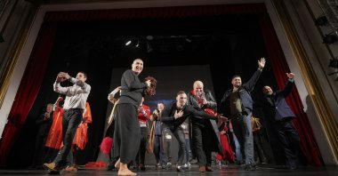 Inmates salute the public after performing in the “State of Siege,” by French author Albert Camus, a play describing a totalitarian Spanish regime during the plague, at the Nottara Theater in Bucharest, Romania, Nov. 24, 2021. (AP Photo)