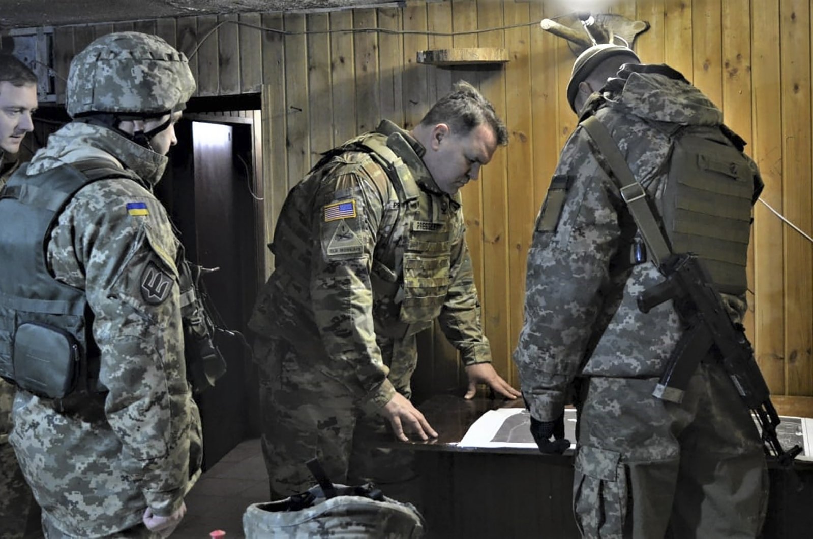 Attache of the Land Forces at the U.S. Embassy in Ukraine Col. Brandon Presley looks at the map during the visit by a delegation of the U.S. Embassy in Ukraine to the Joint Forces operation area in the war-hit Donetsk region, Ukraine, Nov. 19, 2021. (AFP Photo)