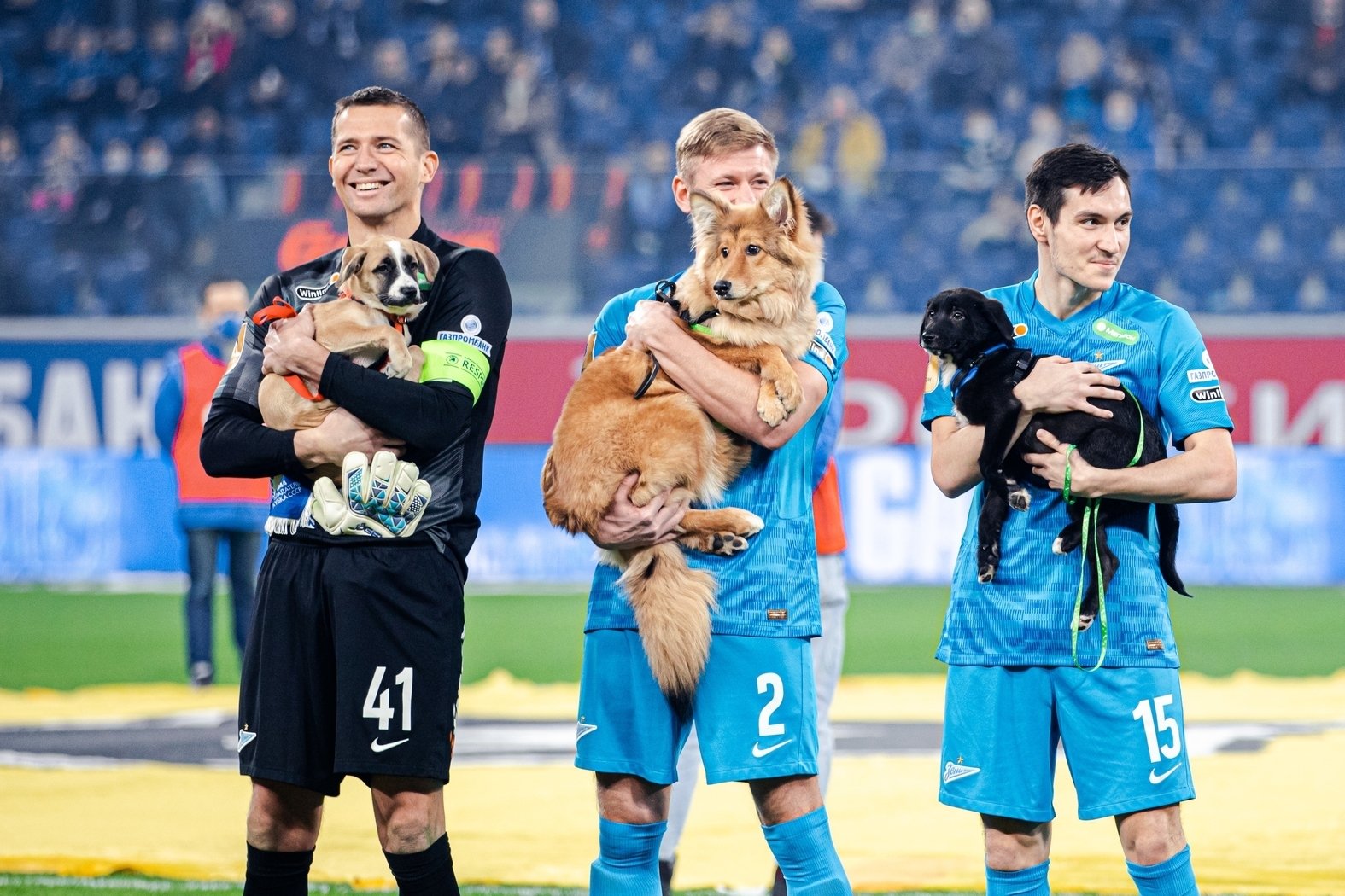 Zenit players Mikhail Kerzhakov (L), Dmitri Chistyakov (C) and Vyacheslav Karavaev can be seen holding dogs, before the start of the Russian Premier League match against Rostov at the Gazprom Arena, Saint Petersburg, Russia, Dec. 3, 2021. (Photo from Football Club Zenit website)
