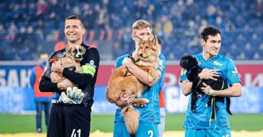 Zenit players Mikhail Kerzhakov (L), Dmitri Chistyakov (C) and Vyacheslav Karavaev can be seen holding dogs, before the start of the Russian Premier League match against Rostov at the Gazprom Arena, Saint Petersburg, Russia, Dec. 3, 2021. (Photo from Football Club Zenit website)
