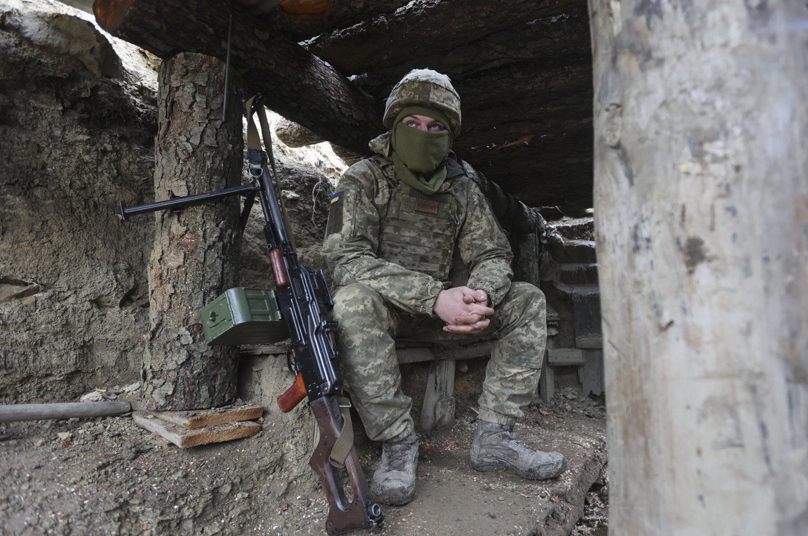 Ukrainian soldiers sits in a fighting position on the line of separation from pro-Russian rebels near Debaltsevo, Donetsk region, Ukraine, Dec 3, 2021.  (AP Photo)
