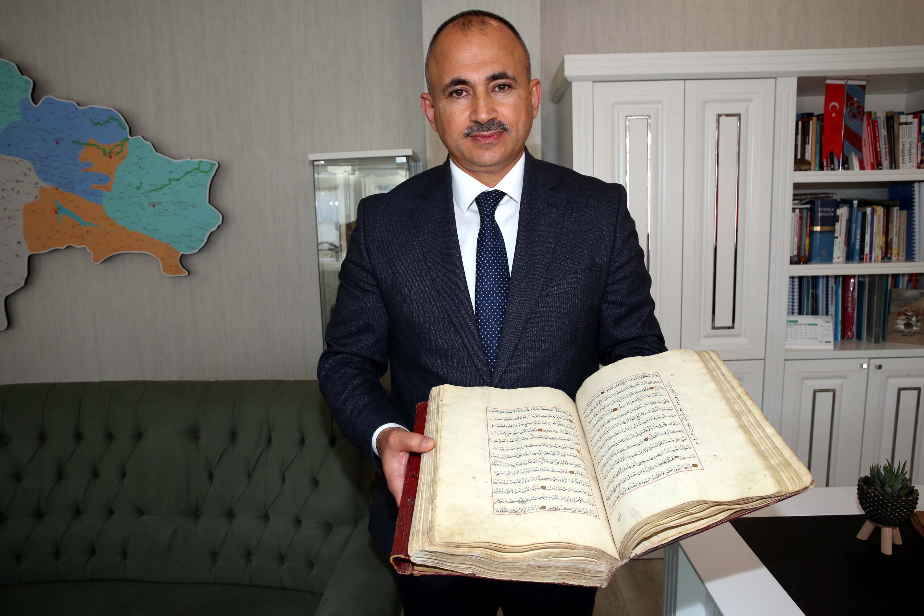 Tokat Provincial Director of National Education Murat Küçükali holds one of the Qurans found in a high school library in Zile district, Tokat province, Turkey, Dec. 3, 2021. (AA Photo)