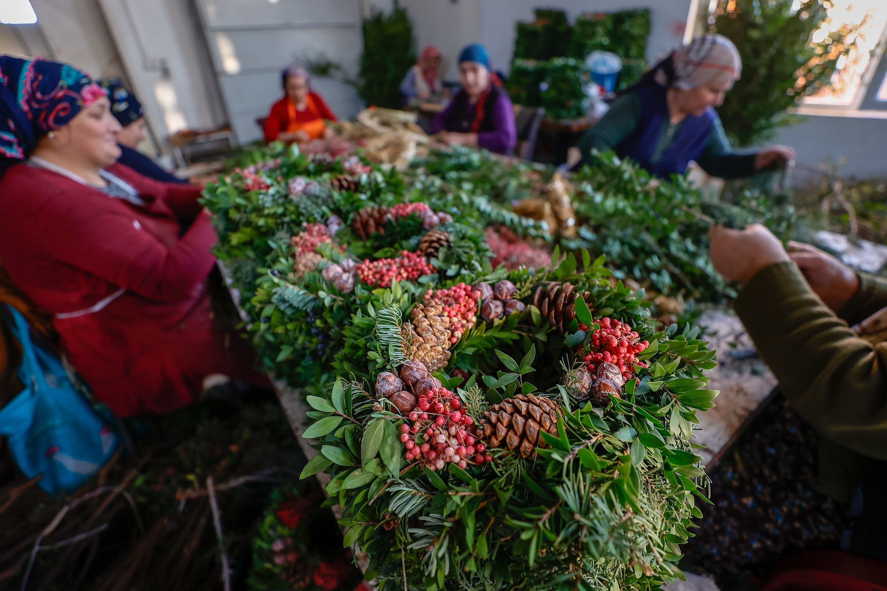 Women work on wreaths for the upcoming Christmas and New Year’s Eve holidays, in the southern province of Antalya, Turkey, Dec. 5, 2021. (AA Photo)