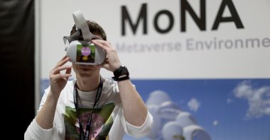 A man wears a VR headset during the DCentral Miami conference at the Miami Airport Convention Center, in Miami, Florida, U.S., Dec. 1, 2021. (AFP Photo)