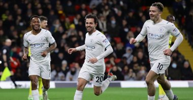 Manchester City's Bernardo Silva celebrates a goal with Jack Grealish and Raheem Sterling in a Premier League match against Watford, Vicarage Road, Watford, England, Dec. 4, 2021. (Reuters Photo)