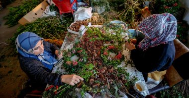 Women work on wreaths for the upcoming Christmas and New Year’s Eve holidays, in the southern province of Antalya, Turkey, Dec. 5, 2021. (AA Photo)