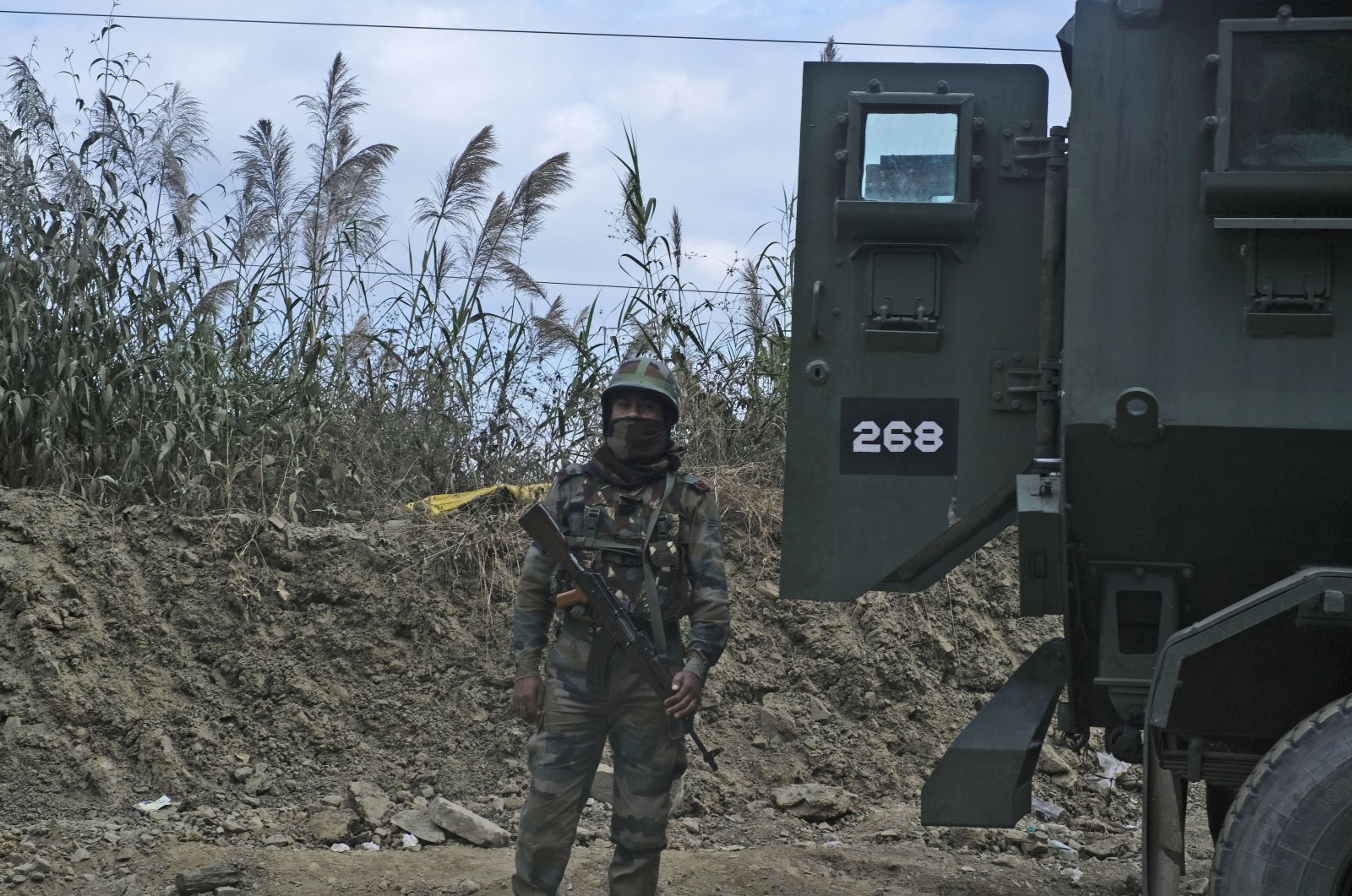 An Indian Army soldier stands guard on a highway on the outskirts of Kohima, capital of northeastern Nagaland state, India, Dec. 5, 2021. (AP Photo)
