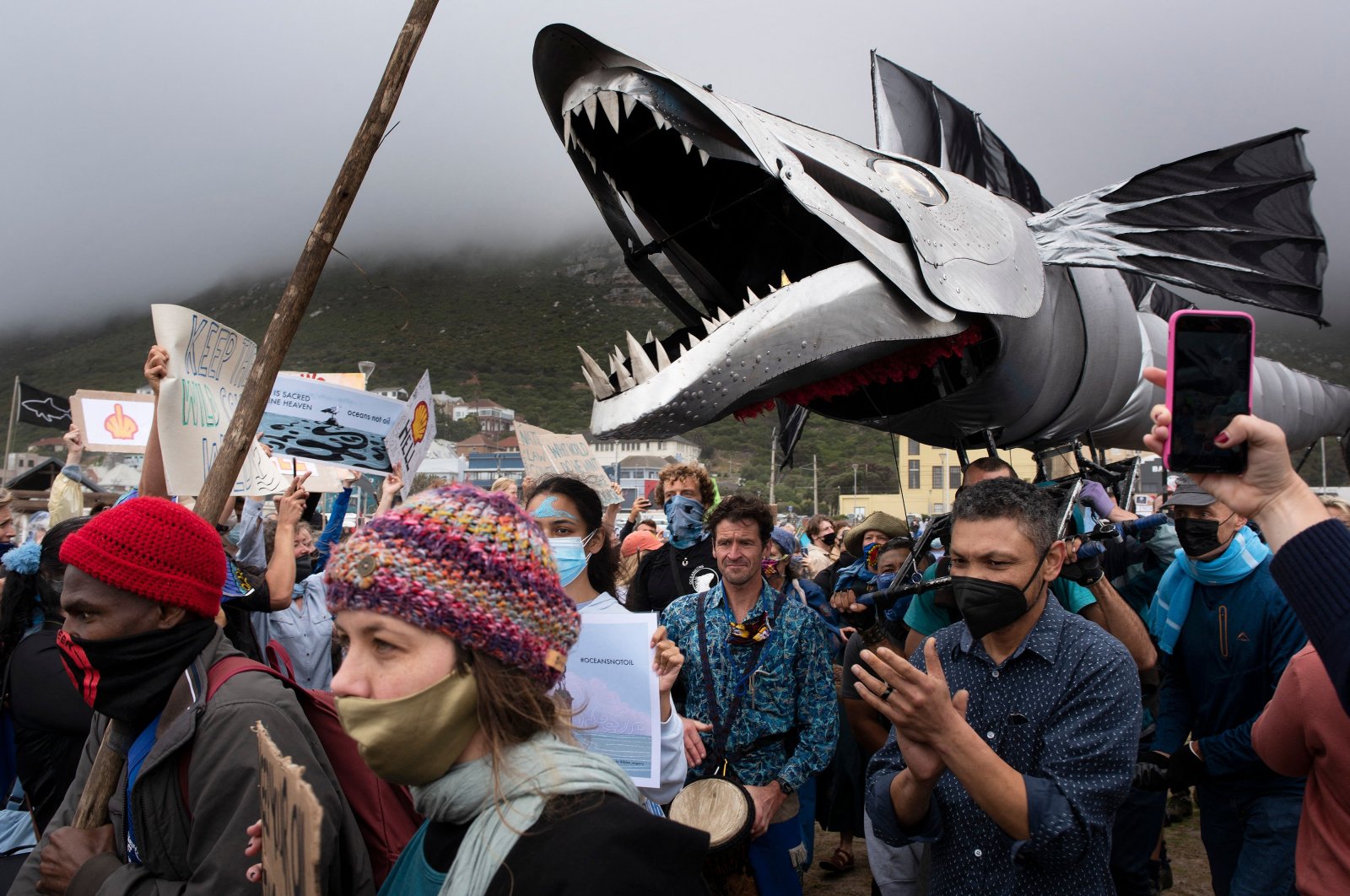 A giant puppet of a snoek, a type of common local mackerel, is displayed as hundreds of people take part in a protest against the plan by Dutch oil company Shell to conduct underwater seismic surveys along South Africa&#039;s east coast, at Muizenberg Beach, in Cape Town, Dec. 5, 2021.