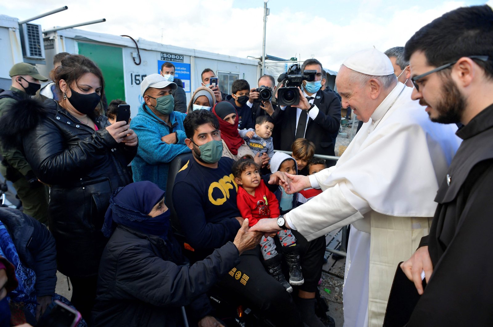 Pope Francis (2nd R) meets refugees at the Reception and Identification Center in Mytilene on the island of Lesbos, Dec. 5, 2021. (VATICAN MEDIA / AFP) /