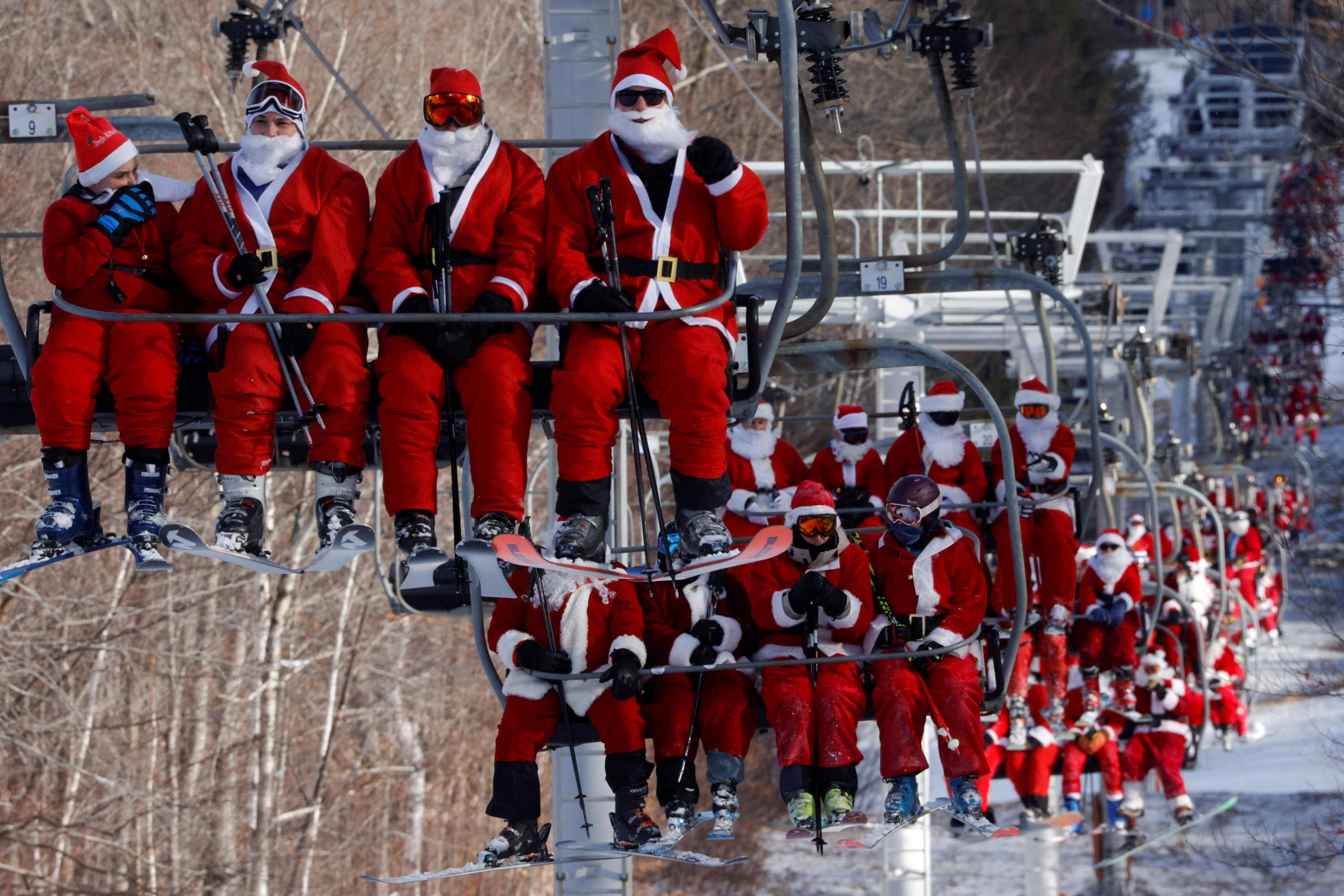 Skiers dressed as Santa Claus ride the lifts to participate in the charity Santa Sunday at Sunday River ski resort in Bethel, Maine, U.S., Dec. 5, 2021. (Reuters Photo)
