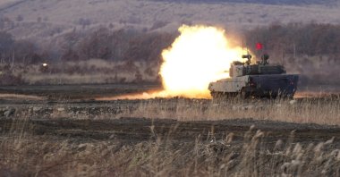 A Japanese Ground-Self Defense Force (JGDDF) Type 90 tank fires its gun at a target during the annual drill with live ammunitions exercise at Minami Eniwa Camp, in Eniwa, northern Japan island of Hokkaido, Dec. 6, 2021. (AP Photo) 