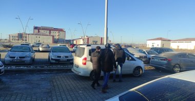 Plainclothes police officers escort a FETÖ suspect to a car, in Kars, eastern Turkey, Dec. 6, 2021. (DHA PHOTO) 