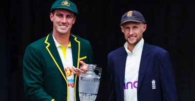 Australia captain Patrick Cummins (L) and England captain Joe Root (R) pose with the Ashes trophy at the Gabba, Brisbane, Australia, Dec. 5, 2021. (AFP Photo)