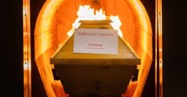 A deceased person in a coffin labelled “SARS-CoV-2 positive – Corona” is cremated in an oven at the crematorium “Die Feuerbestattungen Hildesheim,” in Giesen, Lower Saxony, Germany, Nov. 25, 2021. (Getty Images)